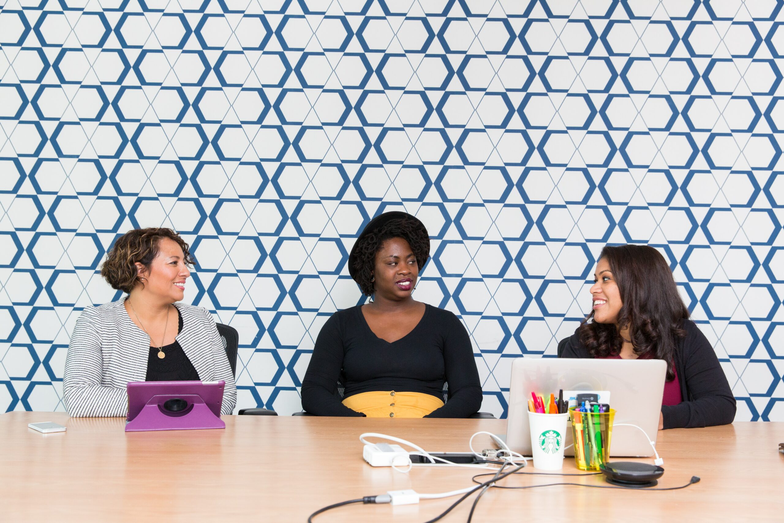 a diverse panel of recruiters leveraging diversity recruiting software on their laptops for inclusive hiring.