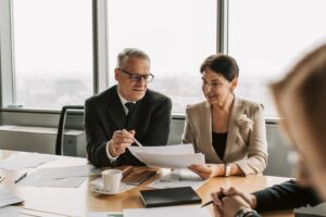 Homme et femme lisant une lettre de référence lors d'un entretien d'embauche dans un bureau. 