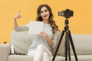 A woman recording a video resume for a job. 